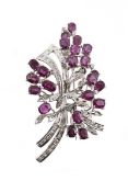 A 1970s ruby and diamond spray brooch, set with claw set oval cut rubies, with eight cut diamond