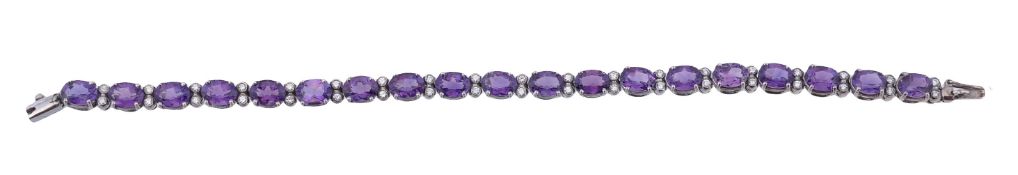 An amethyst and diamond bracelet, the oval cut amethysts in four claw settings interspaced with