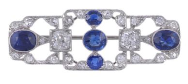 A sapphire and diamond brooch, circa 1920, the openwork rectangular panel set with oval cut