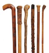 A stained thornwood walking stick, 20th century, 96cm high; a stained hardwood walking stick, early