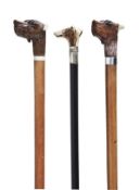 Two carved and stained wood and malacca mounted system walking sticks, early 20th century, each