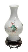 A famille verte bottle vase, Kangxi period, decorated with a fisherman gazing at a bird amid a