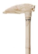 An Anglo-Indian ivory walking stick, late 19th century, the horizontal grip carved as a stylised