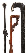 An Indian carved ebony and bone mounted walking stick, early 20th century, the handle modelled as