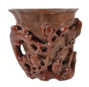 A Large Bamboo Libation Cup 0of lobed, tapered form carved in high relief to the exterior with