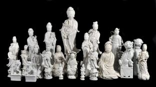 Fifteen Chinese blanc de Chine figures of Guanyin and He Xiangu, of various sizes, depicted in