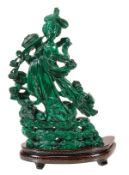 A Chinese malachite carving of a maiden immortal, she stands on a base of stylised clouds as she