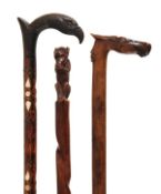 A Continental, possibly Spanish carved and stained walnut walking stick, early 20th century, the