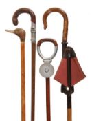 Three stained hardwood shooting sticks, mid 20th century, one with crook handle and folding metal