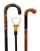 A horn crook handled walking stick, early 20th century, the shaft of three horn sections above a