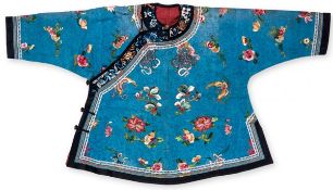 A Chinese silk informal jacket, 19th century, of brilliant turquoise satin finely embroidered with