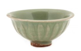 A Yaozhou celadon bowl, Song/Jin period, raised on a tall foot carved around the exterior with