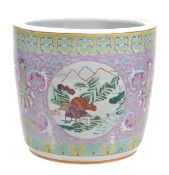 A Chinese famille rose jardiniere decorated with reserve panels featuring ladscape scenes amid a