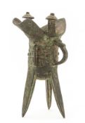 A bronze ritual tripod wine vessel, jue, Qing dynasty, the deep body raised on slightly curved