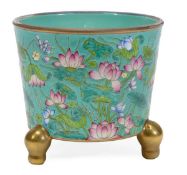 A Chinese famille rose jardiniere decorated with blooming lotuses amid a turquoise ground, standing