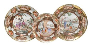 A set of three Chinese export famille rose mandarin patterns plates painted with figures in