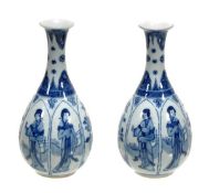 A pair of Chinese blue and white vases of pear shaped body decorated with panels bearing female