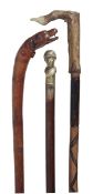 A Victorian carved and stained wood walking stick, late 19th century, the integral grip modelled as