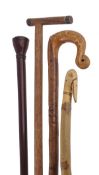 A stained hardwood, possibly padouk walking stick, early 20th century, the turned and tapered knob