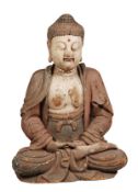 A Chinese wood figure of a Buddha, seated with crossed legs and hands, the chest bared, clothed in