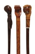 A carved and stained hardwood and palmwood mounted walking stick, Pitcairn Island, early 20th