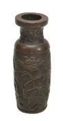 A small bronze cylindrical vase, Ming, decorated with relief designs of magnolias and pitted rocks,