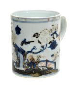A Chinese blue and white tankard decorated with a continuous garden scene featuring blossoming