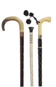 A faux ivory and white metal mounted horn walking stick, early 20th century, the grip with a