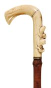 A Victorian carved marine ivory mounted bamboo walking stick, circa 1870, the two section semi-