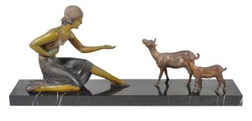 After Demetre Chiparus, a painted spelter group of a woman with goats, on a rectangular marble