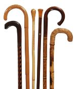 A stained hardwood and parquetry walking stick, late 19th century, the shaft with vertical lines of