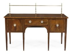 A Regency mahogany sideboard, circa 1815, with a brass gallery, with a central drawer flanked by