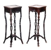 A pair of Chinese carved hardwood pedestal stands, late 19th century/early 20th century, each