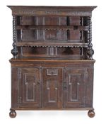 A Continental oak dresser, circa 1680 and later, the moulded cornice with scroll carved detail,