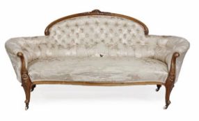 A Victorian walnut framed and upholstered settee, circa 1870, with a button upholstered back with