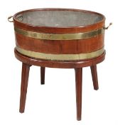 A George III mahogany and brass bound oval wine cooler, circa 1780, the interior lead lined, with