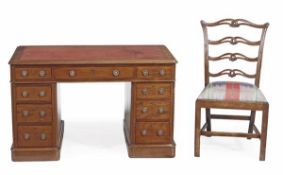 A Victorian mahogany pedestal desk, circa 1880, with a red tooled leather inset, above an
