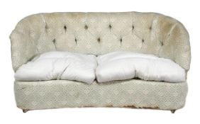 An upholstered settee by Lenygon and Morant, 20th century, of serpentine form, the button