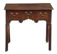 A George III mahogany side table, circa 1760, the rectangular top above an arrangement of three