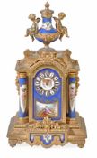 A French Louis XVI style porcelain inset gilt metal mantel clock, late 19th century, the circular