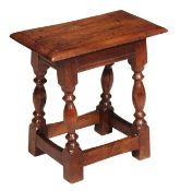 A yew wood joint stool, 18th century, the solid seat with moulded edge, plain frieze on turned and