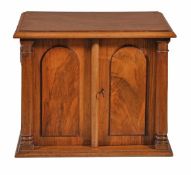 A Victorian walnut table cabinet, last quarter 19th century, with moulded top above two panel