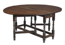 An oak gateleg table, late 17th/early 18th century, with a frieze drawer to either end on ring