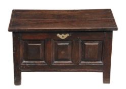 A George II oak coffer bach, circa 1750, the hinged rectangular top above a triple panelled front on
