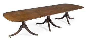 A triple pedestal mahogany dining table in Regency style, of recent manufacture, with two additional