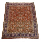 A Bidjar carpet, the red field decorated with boteh and meandering foliage, within navy borders,