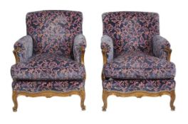 A pair of beech framed and upholstered armchairs, in Louis XVI style, 20th century, each with padded