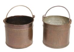 A matched pair of wrought iron mounted copper coal buckets, 19th century, each with swing handle,