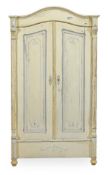 A Continental painted pine wardrobe, late 19th century, with an arched crest above a pair of