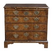 A George I walnut ‘Bachelors’ chest, circa 1725, with a crossbanded moulded top, brushing slide